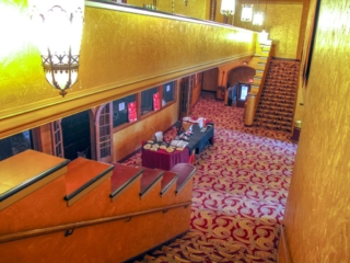 The Smith lobby with gold walls and ornate carpet is prepped for an event