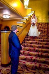 A bride walks down the lobby steps